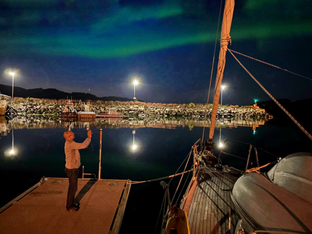 Capturing the Northern Lights in a harbour in Northern Norway, winter